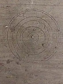 Circular marks above a fireplace