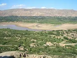 Fields and gardens in the Valley of Daxia River. The river flows to the north (to the left in the picture), into Liujiaxia Reservoir, separating Linxia County (foreground) from Dongxiang Autonomous County (background)