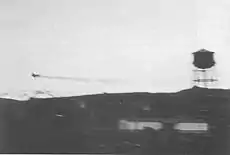 The Zero trailing oil over Dutch Harbor, moments after being hit