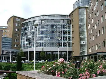 A large brick building with several glass windows.