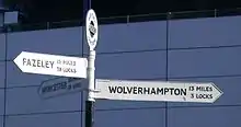 A Royal Label Factory "Geared" canal fingerpost at Old Turn Junction Birmingham, where the Birmingham Canal Navigations Main Line and Birmingham and Fazeley Canal meet. Beneath the distance, the number of locks is given