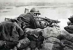 Image 26A Belgian machine gunner at the front lines in 1918, firing a Chauchat machine gun. (from History of Belgium)