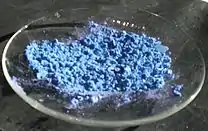 blue powder on a watch glass