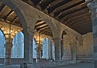 The Broletto at Como has series of arcades, the outer with polychrome voussoirs, supporting a timber roof on brackets.