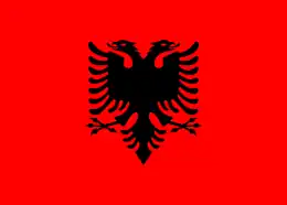 Red flag with a black double-headed eagle in the centre.