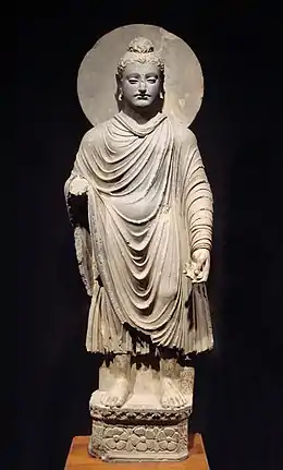 The Buddha wearing kāṣāya robes, c. 200 BCE.