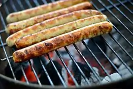 Some sausages grilling