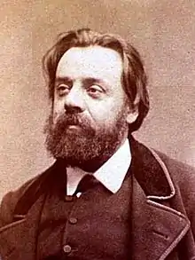 Portrait photograph of Gustave Lefrançais, wearing a beard and a neat suit