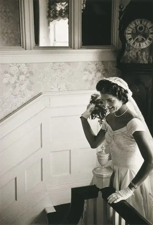 Jacqueline Kennedy throwing the bouquet at her first wedding.