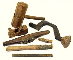 A set of wooden carpentry tools against a white background