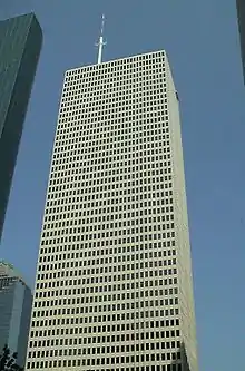 Fifty-floor, rectangular skyscraper with rows of identical windows and minimal ornamentation.