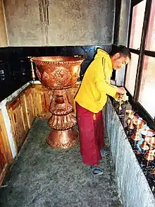 Preparing butter lamps at Thakthok Gompa