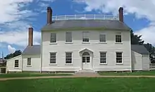 Photograph of a two-story, white clapboard house