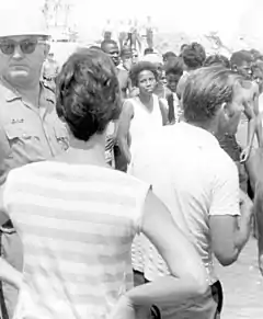 Black and white photograph of segregationists fighting on a beach