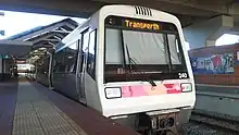 Close up view of a train stopped at a train station platform