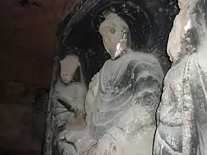 A damaged statue of the Buddha.