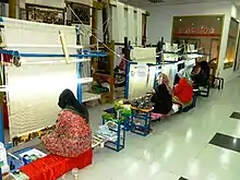 Women weaving silk. Kashgar